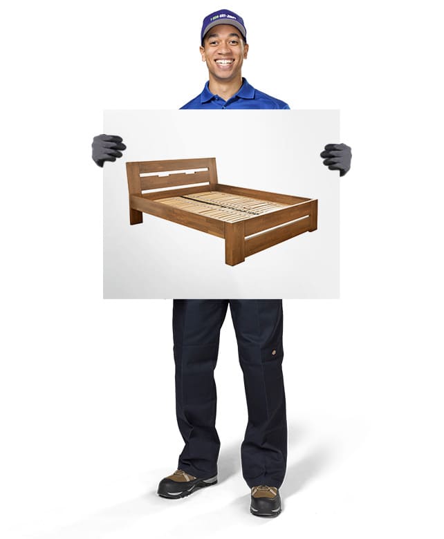 1800-GOT-JUNK? Truck Team Member holding an image of a bed frame