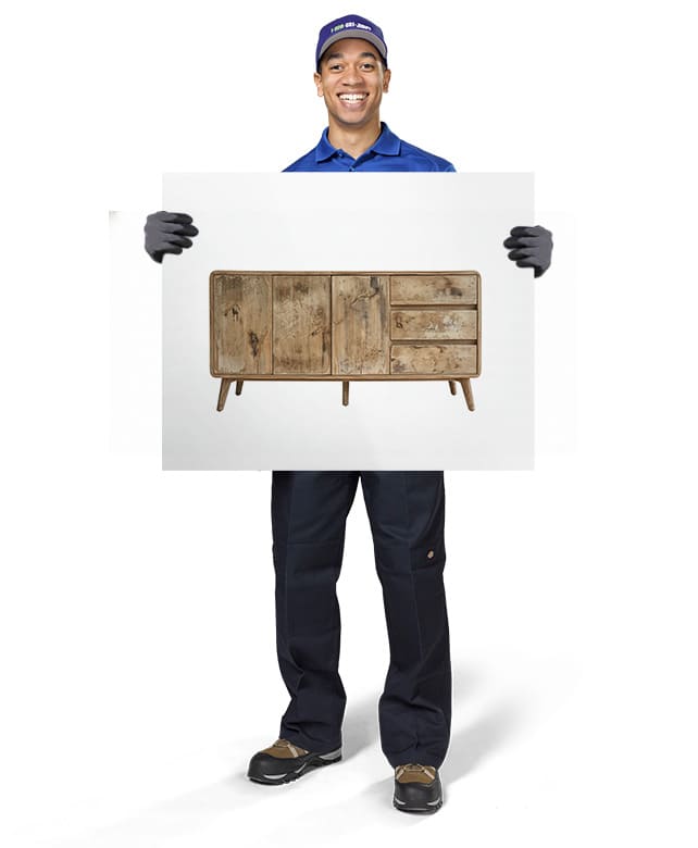 1800-GOT-JUNK? Truck Team Member holding an image of a tv stand