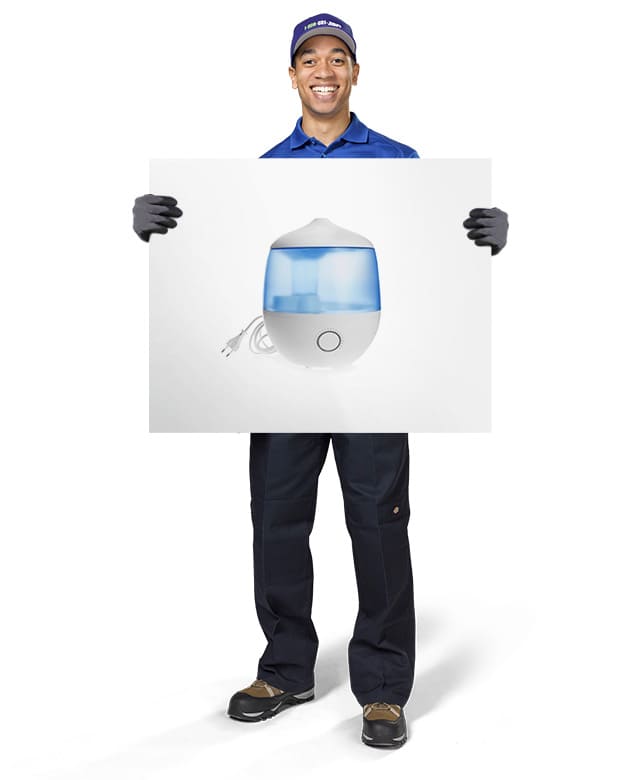 1800-GOT-JUNK? Truck Team Member holding an image of a humidifier