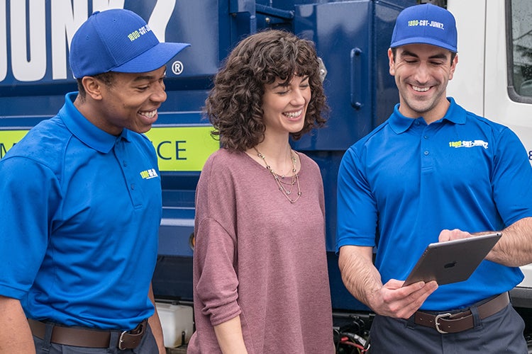 2 Truck Team Members helping a woman