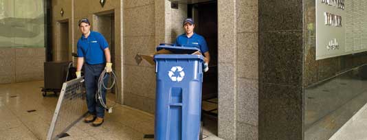 Truck team members carrying junk out of an elevator