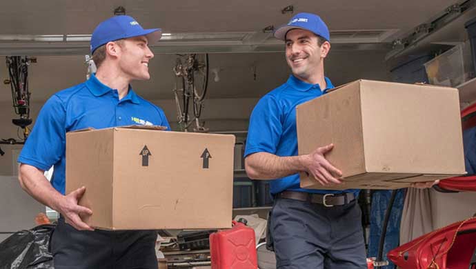 Two uniformed TOM's ready to haul your junk!